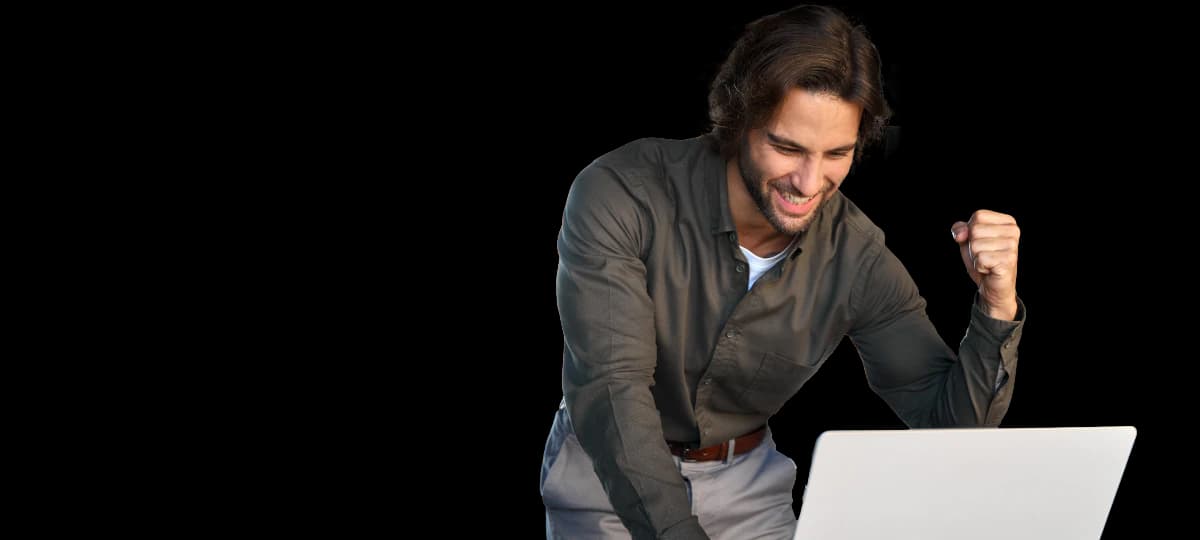 Professional celebrating in front of a laptop